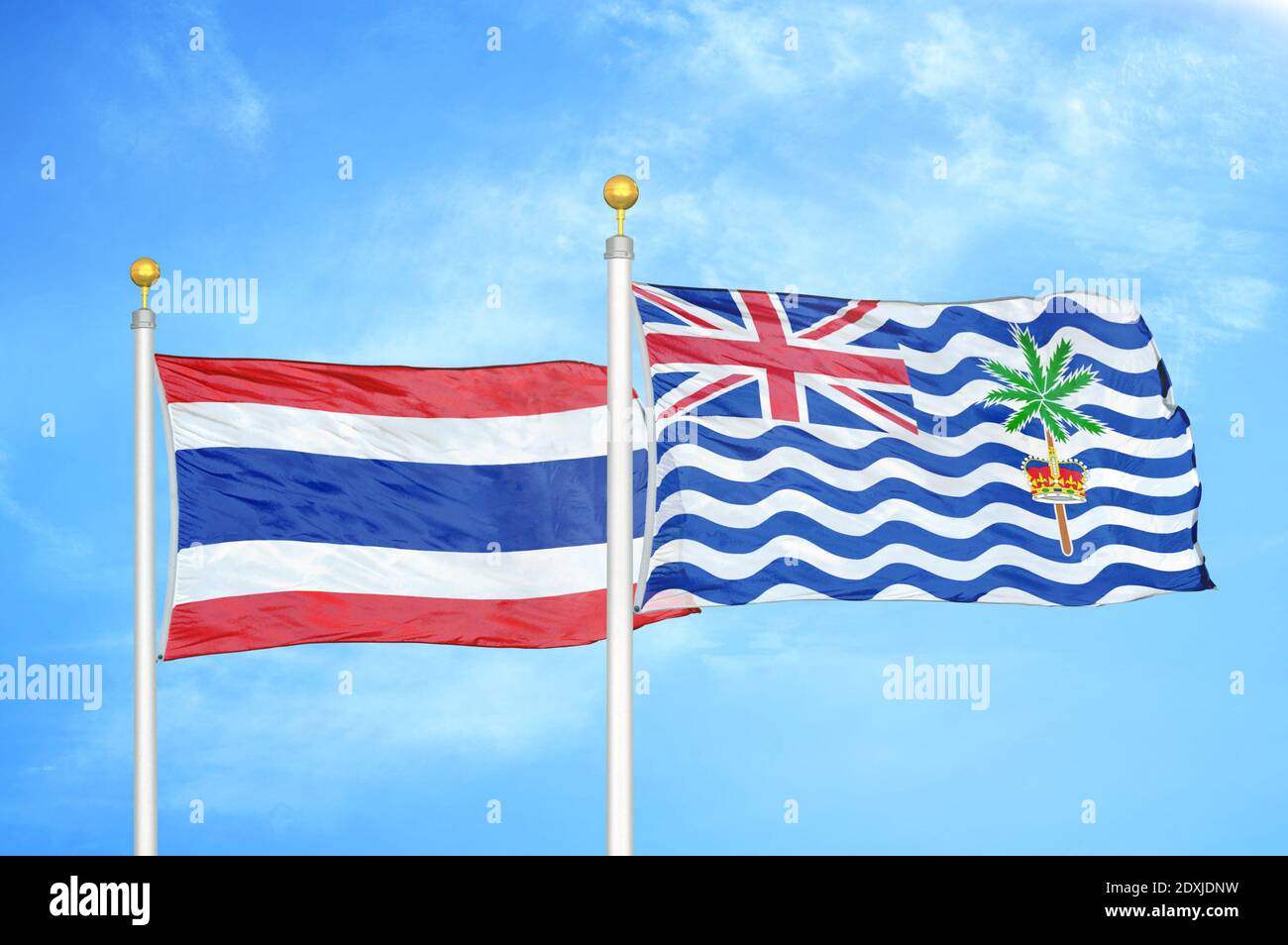 Thaïlande et territoire britannique des Indiens deux drapeaux sur les mâts de drapeaux et ciel bleu Banque D'Images