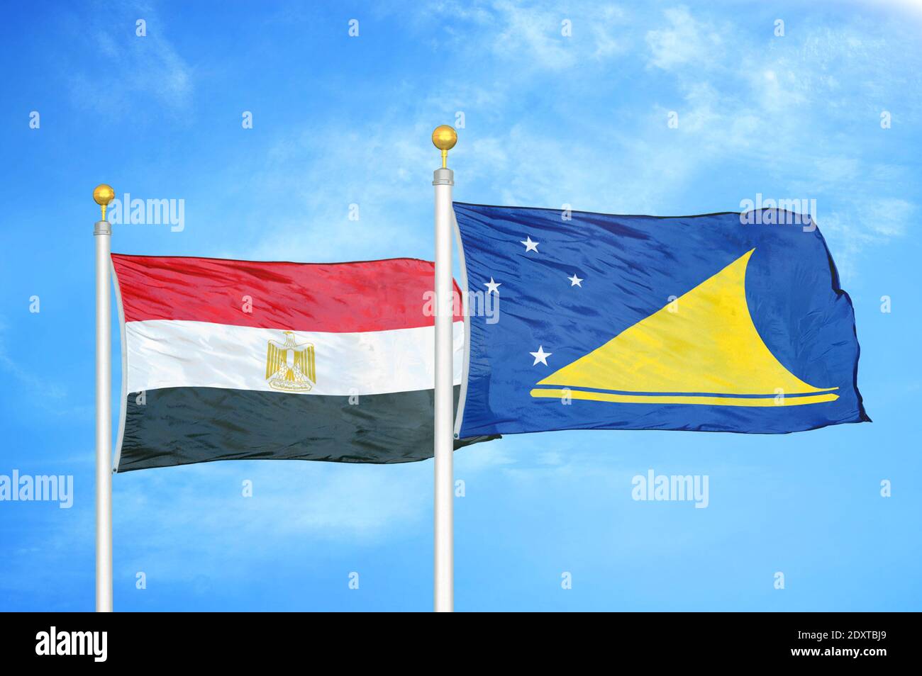 Égypte et Tokélaou deux drapeaux sur les mâts et bleu nuageux ciel Banque D'Images