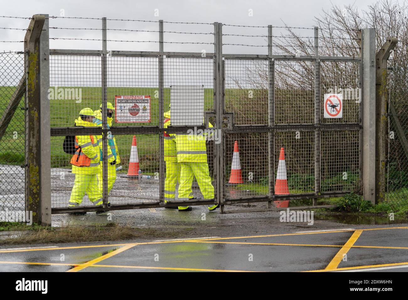 Des gardes vus près d'une porte à l'aéroport de Manston pendant les essais. Les Français ont fermé les frontières avec le Royaume-Uni, craignant qu'une mutation du coronavirus se propage dans le sud de l'Angleterre. Les chauffeurs de camions seront désormais contraints de faire un test de détection du coronavirus avant de pouvoir quitter le Royaume-Uni et entrer en France. Le retard dans les essais et la réticence des Français à ouvrir la frontière ont conduit des milliers de camionneurs à rester coincés sur l'autoroute pendant plusieurs jours, faute d'installations et de nourriture. Banque D'Images