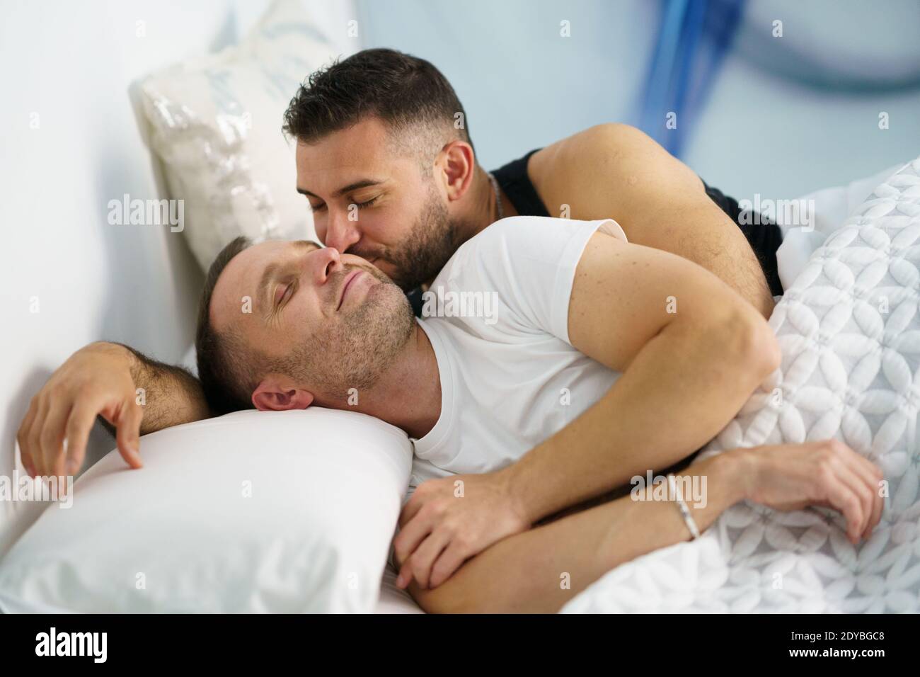 Couple gay allongé sur le lit à la maison Photo Stock - Alamy