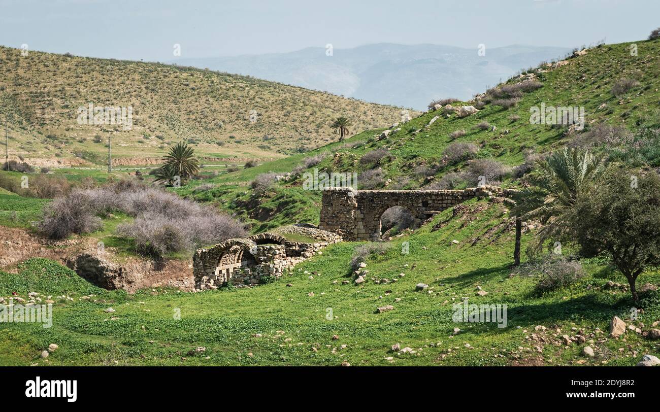 ruines d'un pouf époque moulin à farine de pierre sur wadi lit de ruisseau milkha dans la vallée du jourdain avec les montagnes de la jordanie en arrière-plan Banque D'Images