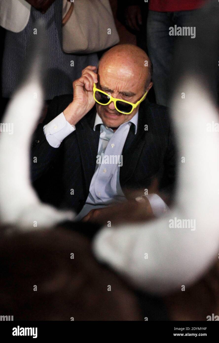 Le maire de Bordeaux, Alain Juppe, essaie des lunettes de soleil jaunes  lors d'une soirée à Bordeaux, au sud-ouest de la France, le 27 juin 2013.  Photo de Patrick Bernard-Quentin Salinier/ABACAPRESS.COM Photo