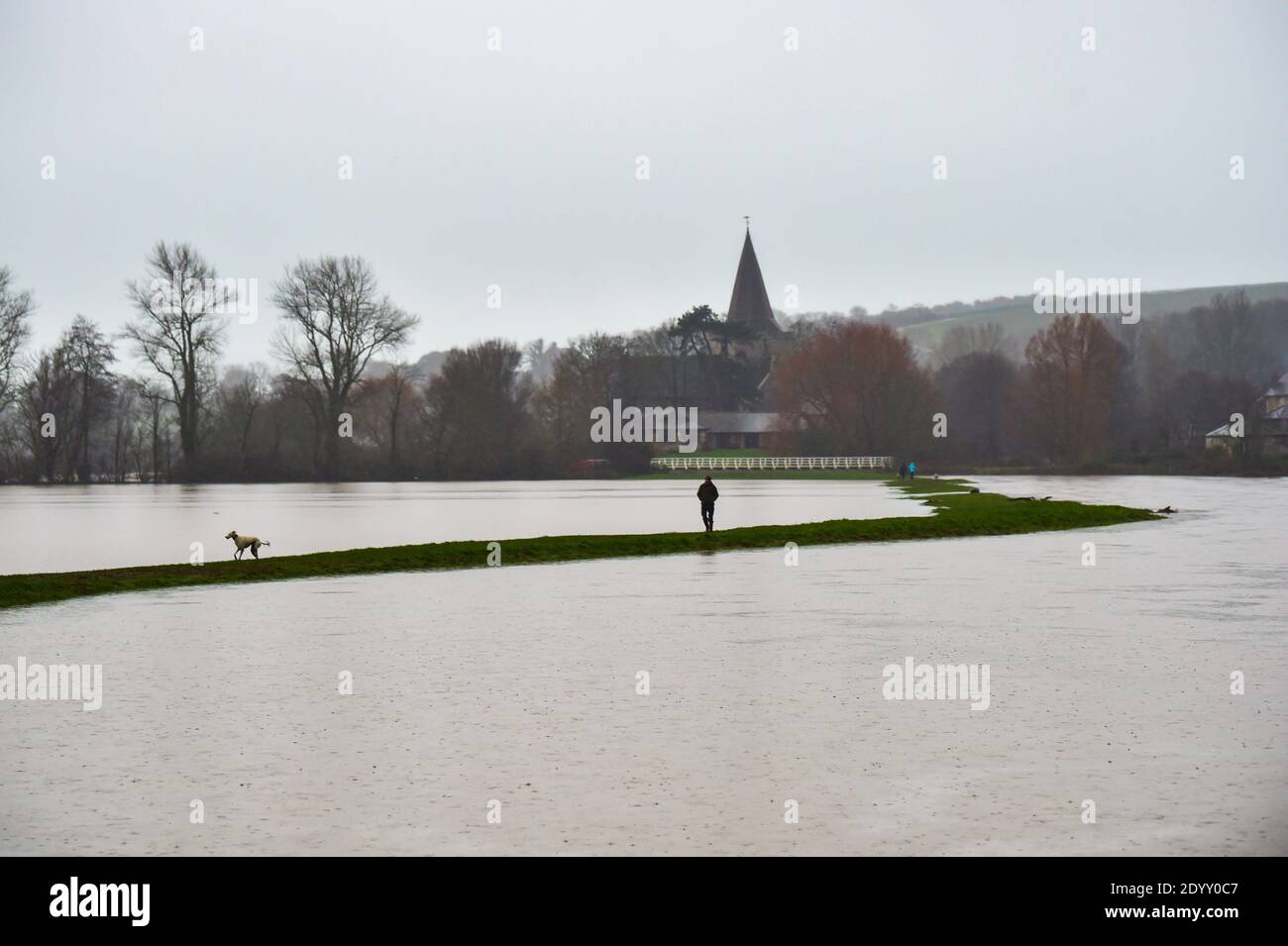 Alfriston Sussex Royaume-Uni 28 décembre 2020 - les marchettes brave le temps humide que les champs et les terres agricoles sont inondés par la rivière Cuckmere près d'Alfriston dans l'est du Sussex après la récente forte pluie et Storm Bella qui a causé des perturbations à travers le Royaume-Uni . Plus de neige et de pluie sont prévues pour le Royaume-Uni au cours des prochains jours : Credit Simon Dack / Alamy Live News Banque D'Images