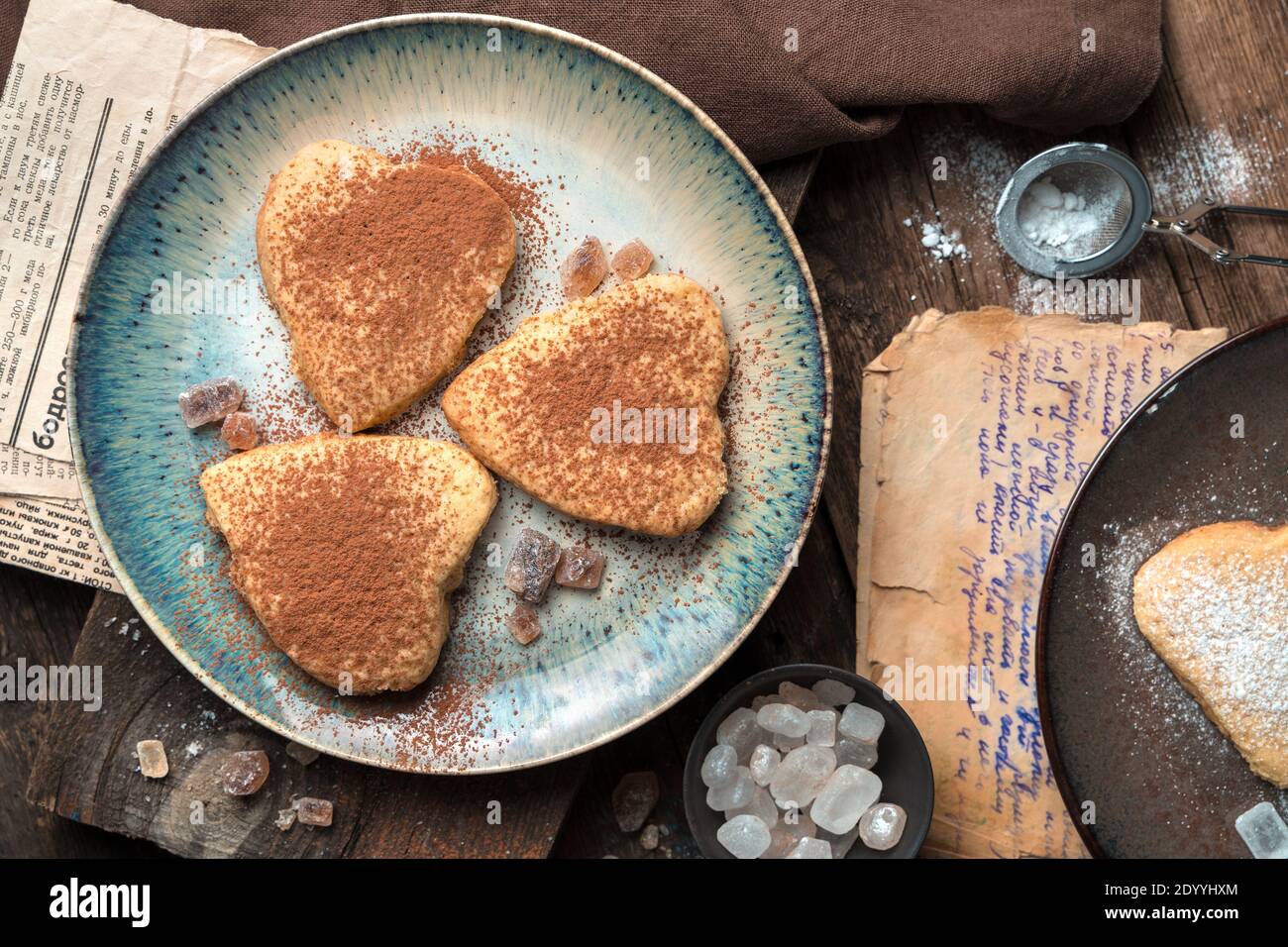 Arrière-plan culinaire avec des biscuits en forme de coeur sur fond vintage. Banque D'Images