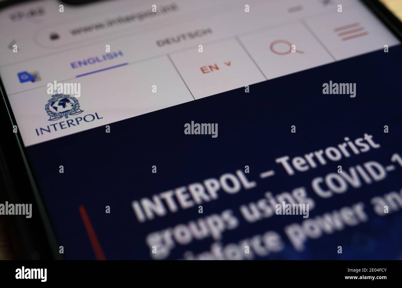 Viersen, Allemagne - décembre 29. 2020: Gros plan du téléphone mobile avec le site Internet d'interpol avec avertissement sur les terroristes Covid-19 Banque D'Images