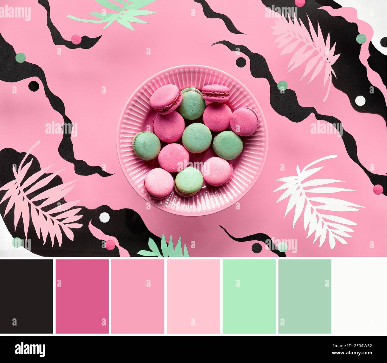 Palette de contretypage des couleurs. Assiette volante de macarons sur fond de papier abstrait avec des meaves de palmier exotiques. Lévitation dans des couleurs pastel, rose, crème Banque D'Images