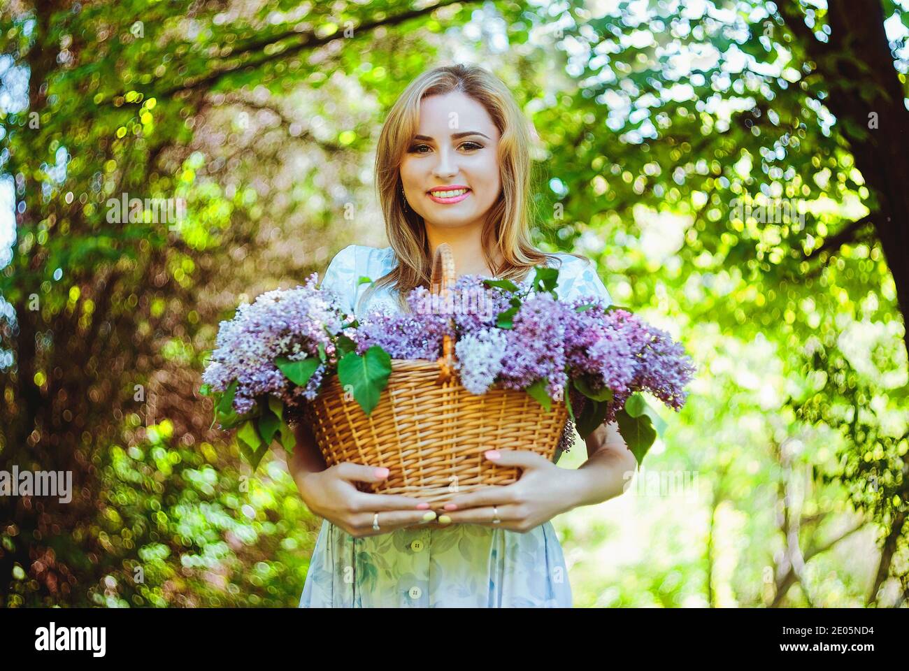 Portrait de la jeune femme en robe bleue dans le jardin de printemps