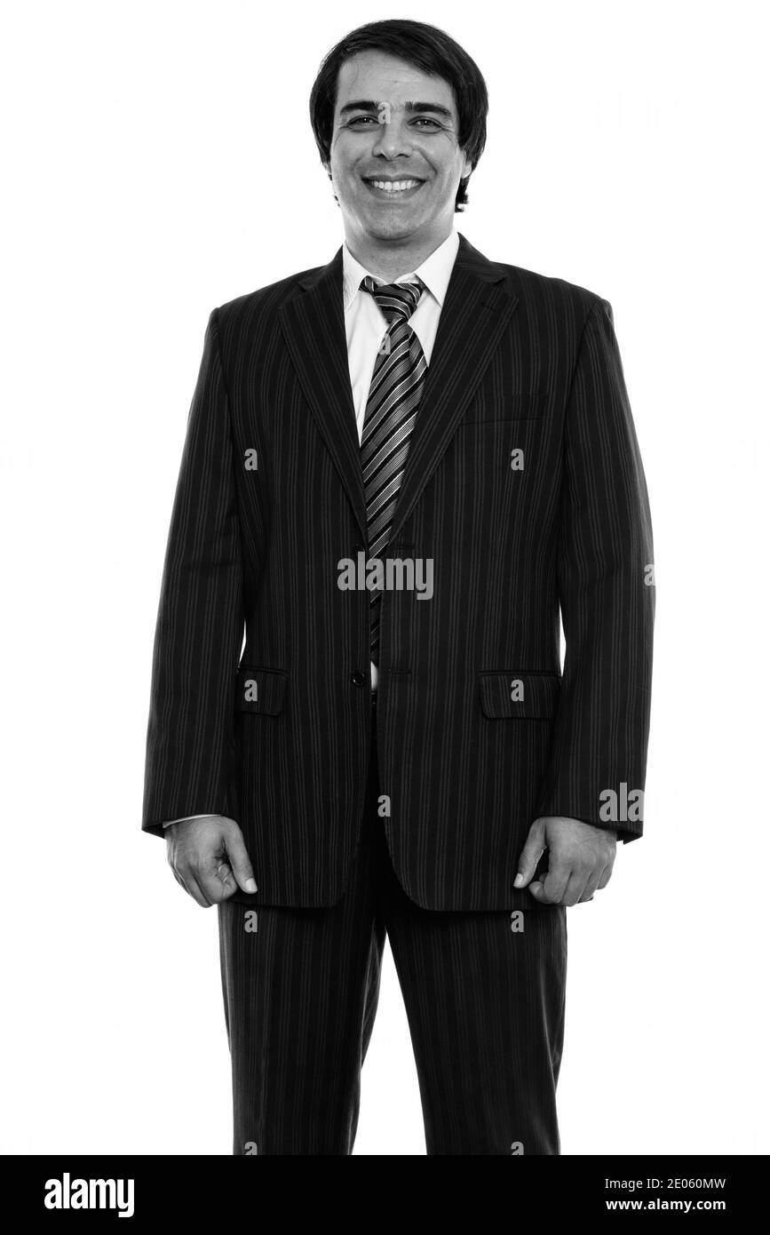 Studio shot of young businessman smiling persan heureux et debout Banque D'Images Studio shot of young businessman smiling persan heureux et debout Banque D'Images