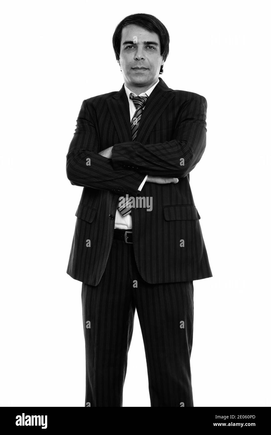 Studio shot of young businessman Persique standing with arms crossed Banque D'Images Studio shot of young businessman Persique standing with arms crossed Banque D'Images