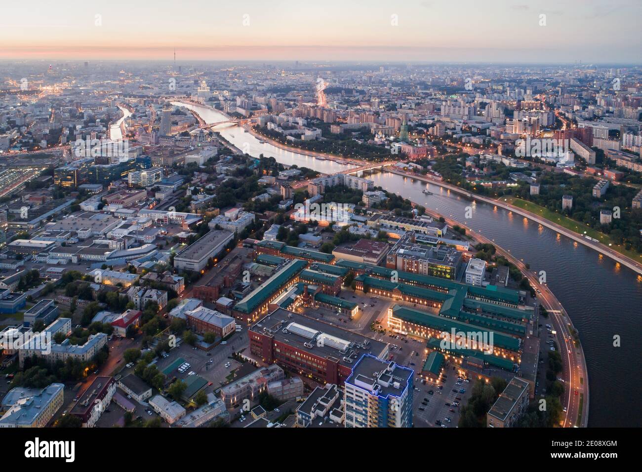 La grande ville et la rivière au coucher du soleil dans le été Banque D'Images