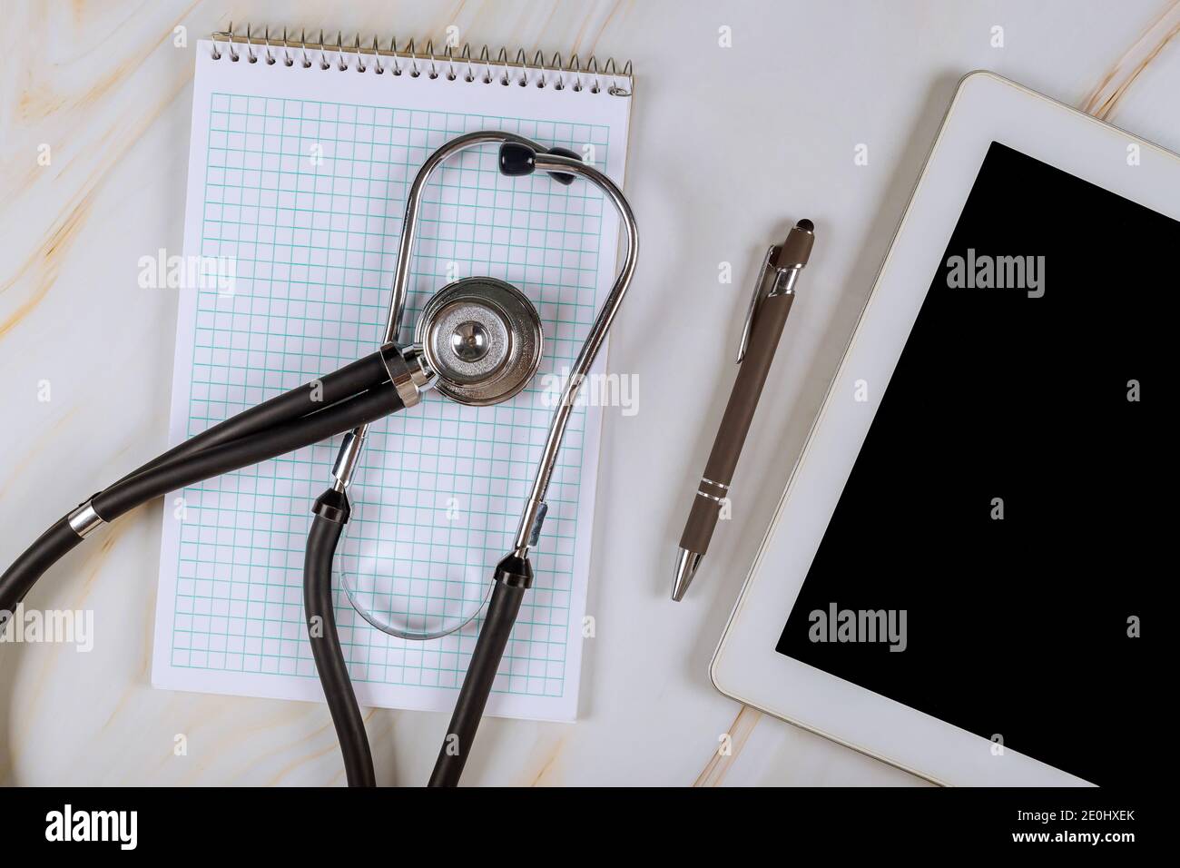 Ordinateur tablette numérique avec stéthoscope médical sur table de marbre sur le lieu de travail du bureau de l'hôpital médical Banque D'Images