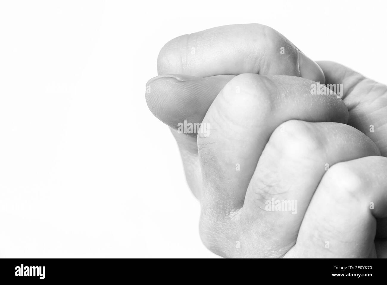 Poing avec le pouce sur un fond blanc Banque D'Images