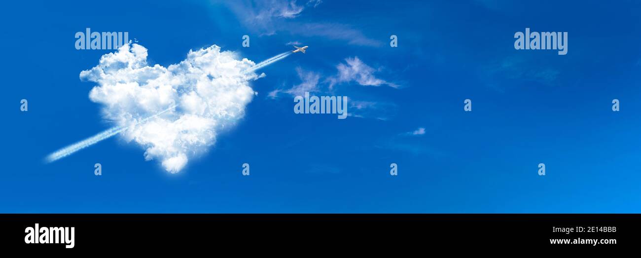 Avion Cupidon dans un nuage en forme de coeur sur fond bleu ciel panoramique. Bannière Web de la Saint-Valentin. Banque D'Images