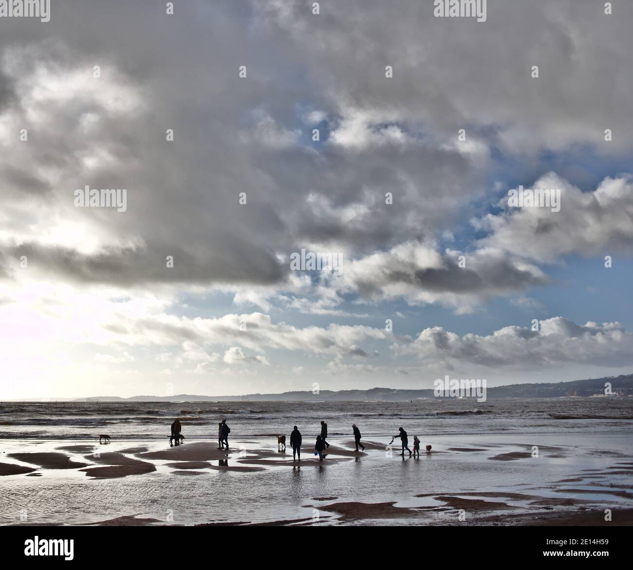 Marcheurs d'hiver sur la plage d'Exmouth, Devon Banque D'Images