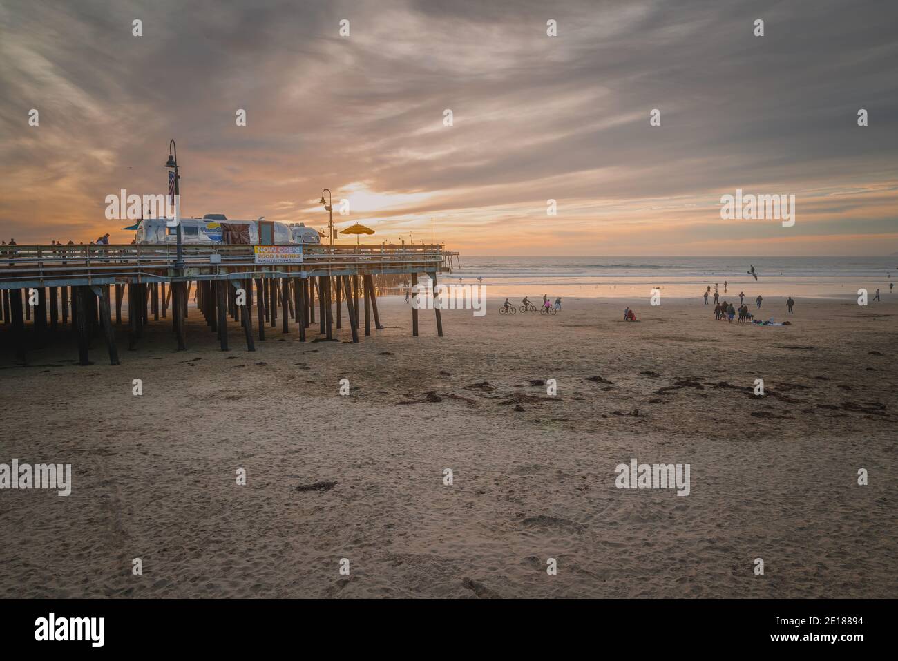 Pismo Beach, Californie, États-Unis - 1er janvier 2021 coucher de soleil sur Pismo Beach, Californie. Une vieille jetée en bois, une plage de sable et des gens qui profitent de la vue sur l'océan Banque D'Images