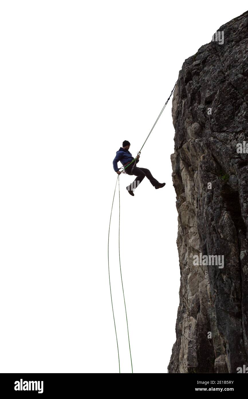 Aventure épique Extreme Sport composite de Rock Climing Homme Rappelling a Cliff. Banque D'Images