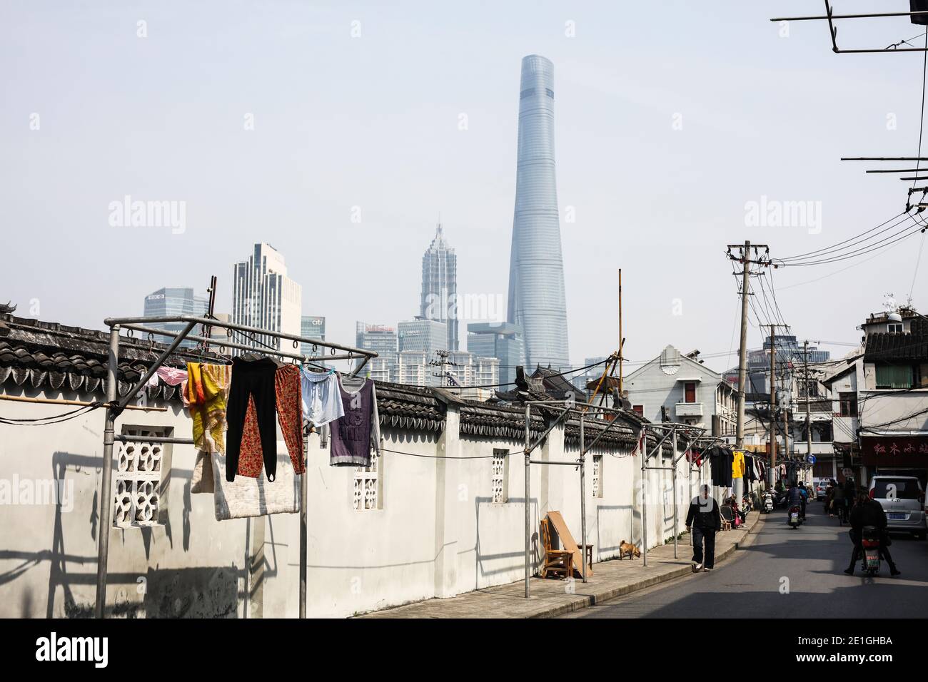 Vieux rencontre nouveau, une rue arrière de Shanghai avec la Tour de Shanghai en arrière-plan. Banque D'Images