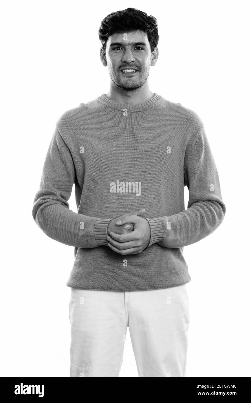 Studio shot of young happy Persian man smiling while standing Banque D'Images Studio shot of young happy Persian man smiling while standing Banque D'Images