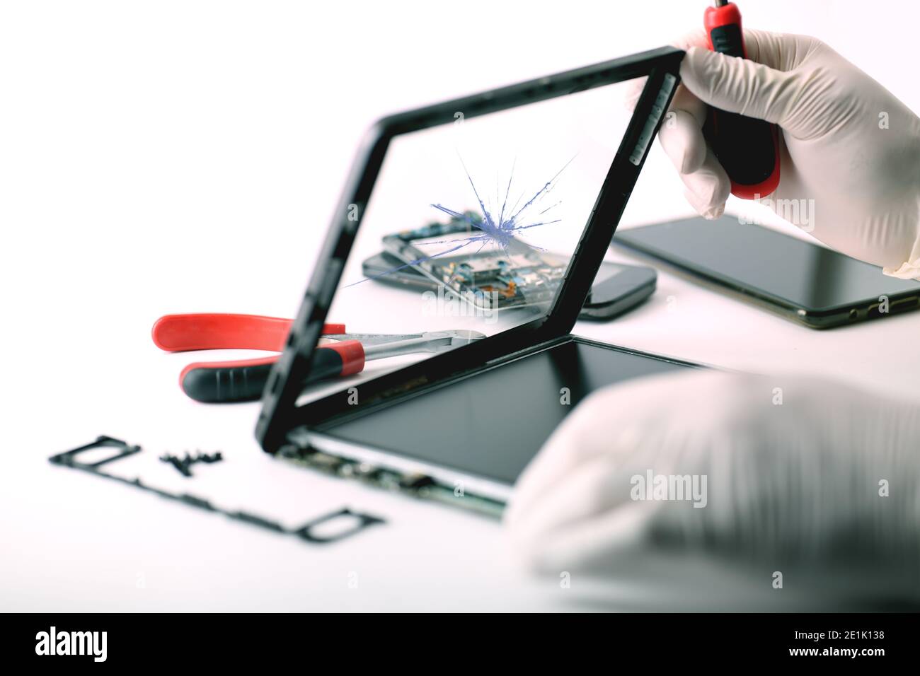 Un technicien répare une tablette cassée Banque D'Images