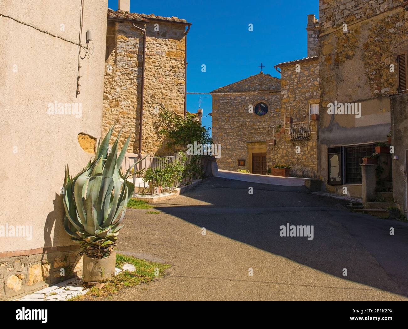 Une rue résidentielle dans le village médiéval historique de Poggio Capanne près de Manciano dans la province de Grosseto en Toscane, Italie. Église du 5e siècle Banque D'Images