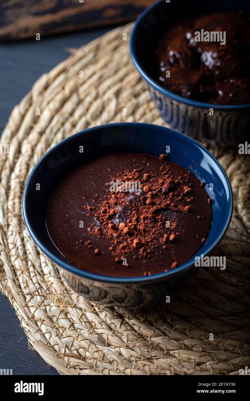Mousse au chocolat noir dans un bol en céramique sur une table en bois.  Pouding au chocolat noir avec poudre de cacao sur le dessus Photo Stock -  Alamy