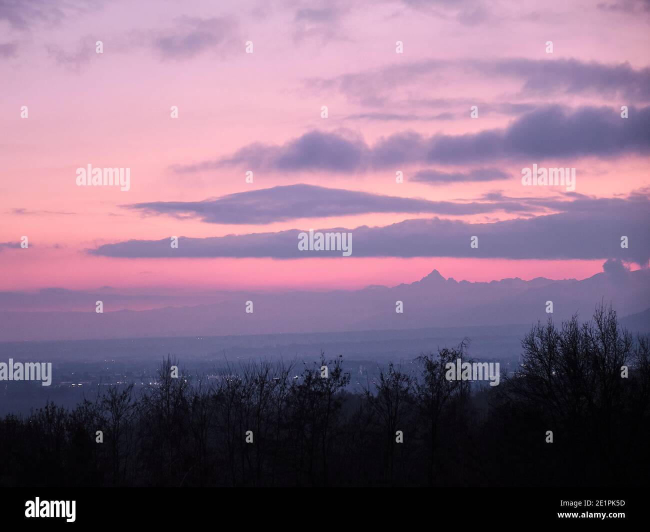 Le profil de l'alp Monviso surplombe la vallée du po immergée dans un ciel rose Banque D'Images