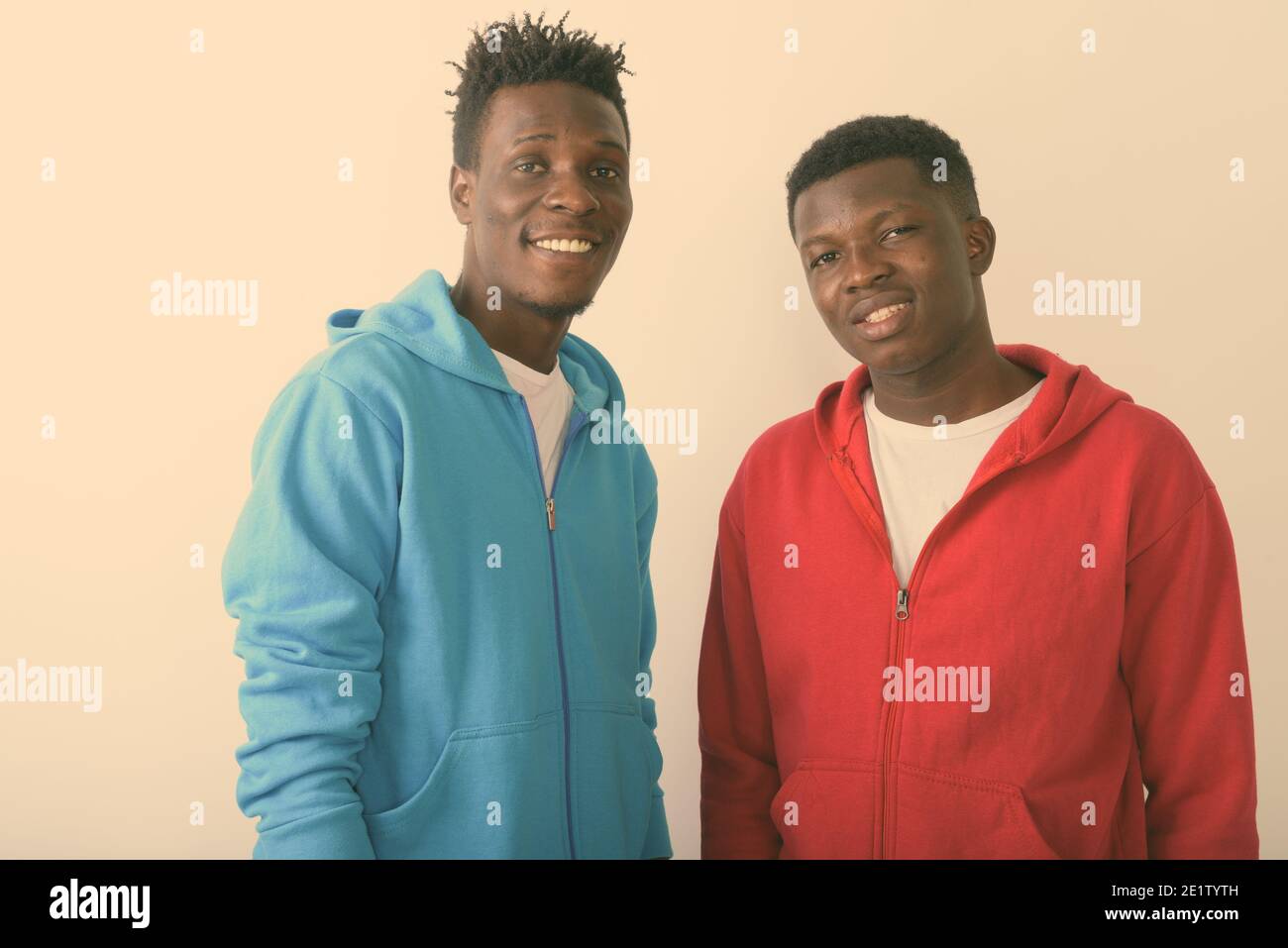 Portrait de deux jeunes happy black African friends smiling together against white background Banque D'Images