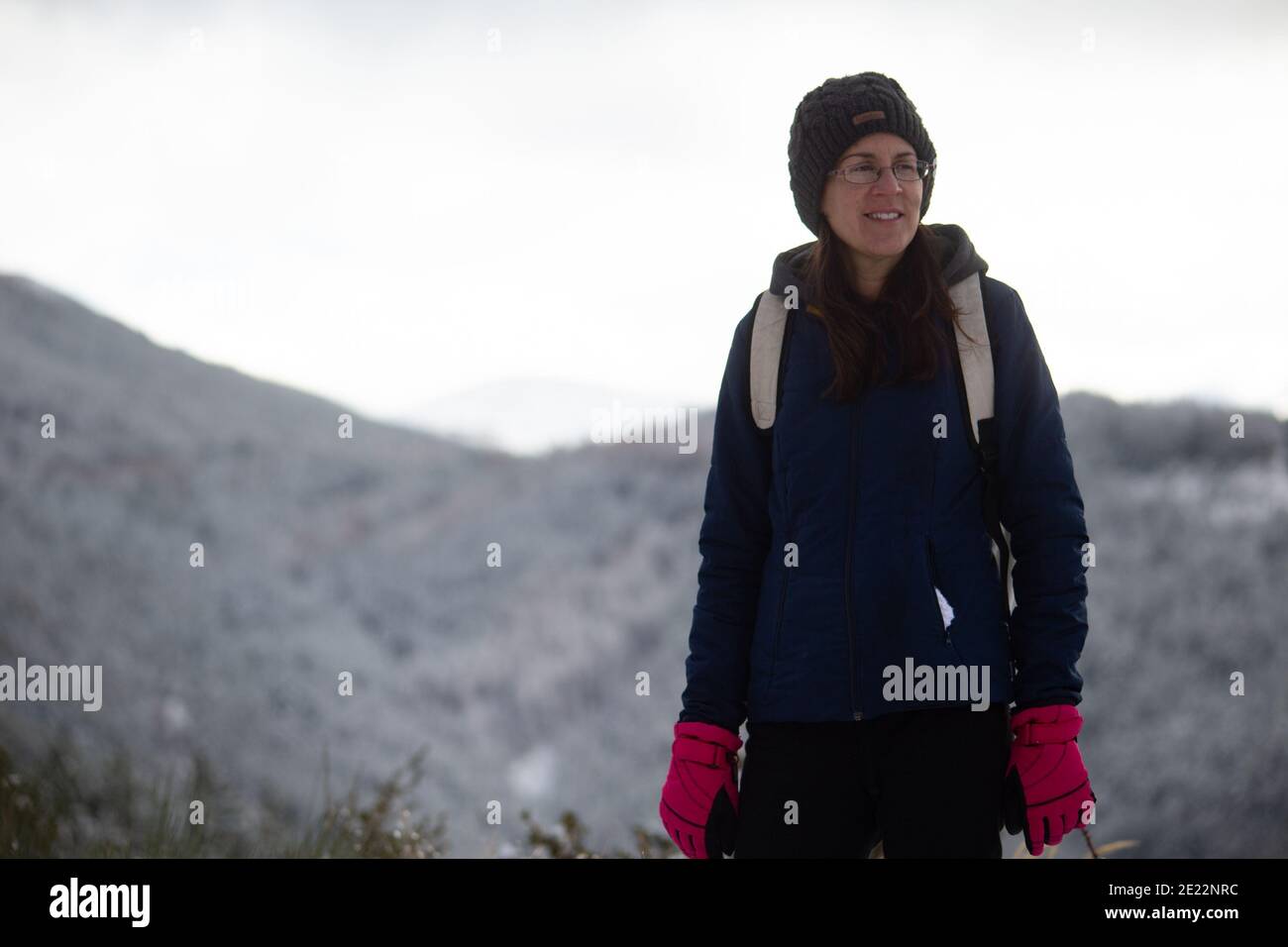 Une femme optimiste regardant la distance un jour d'hiver. Banque D'Images