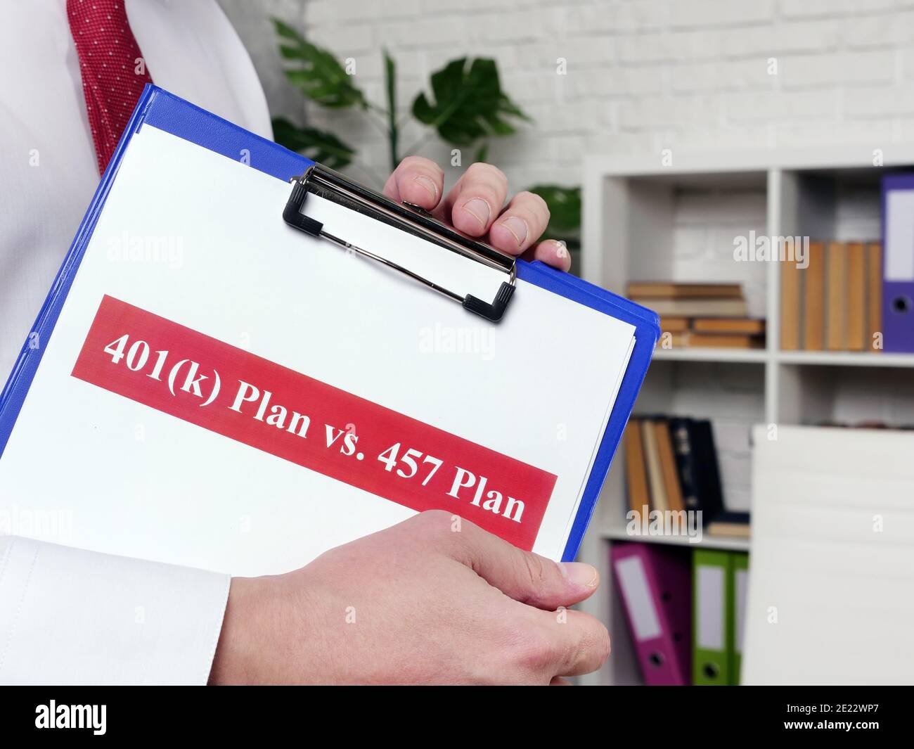 Le Manager présente des documents sur le plan 401k par rapport au concept de comparaison du plan 457. Banque D'Images