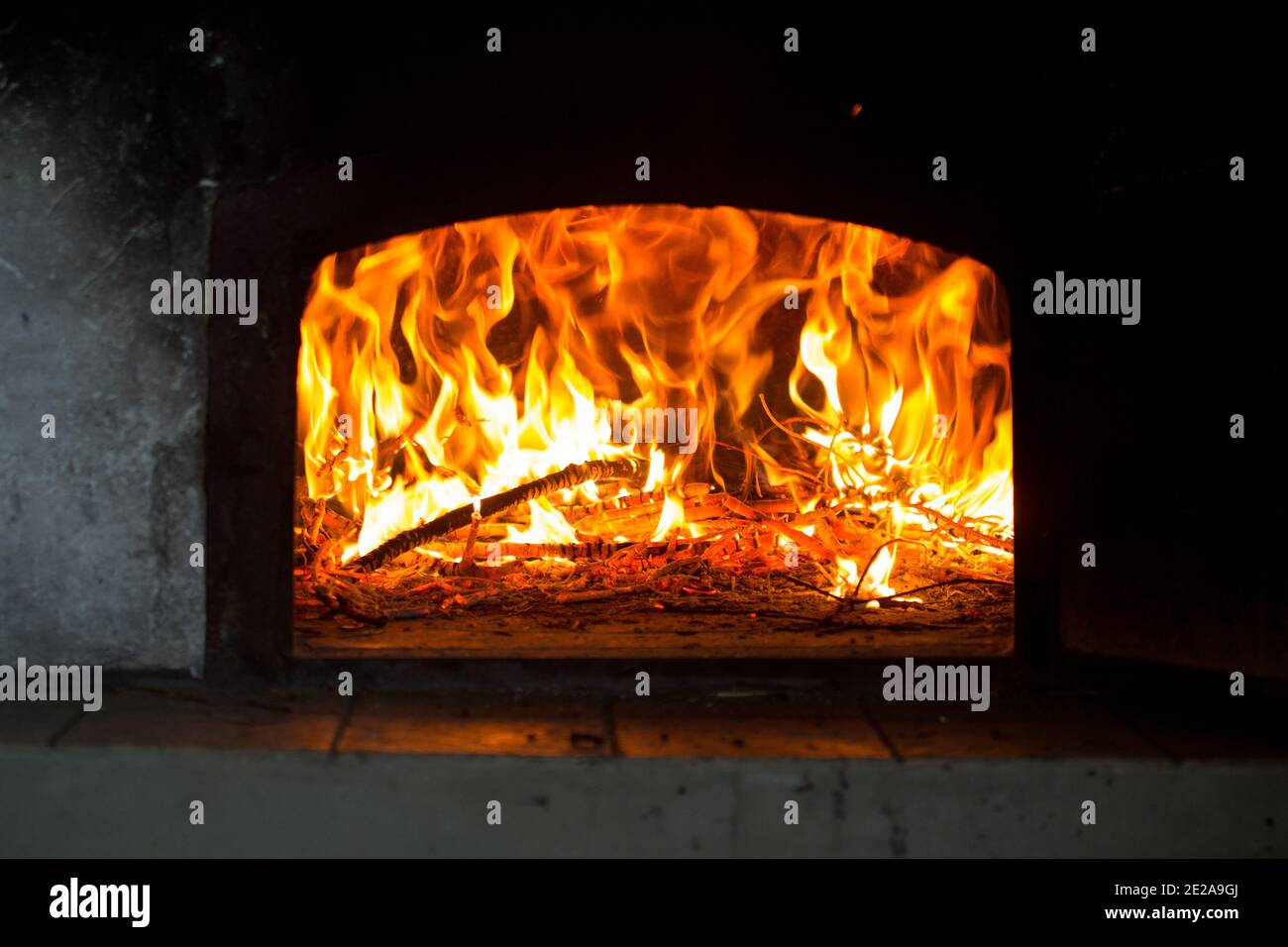 Le feu et les flammes sont vus à l'intérieur d'un vieux four ou four rural à bois. Banque D'Images