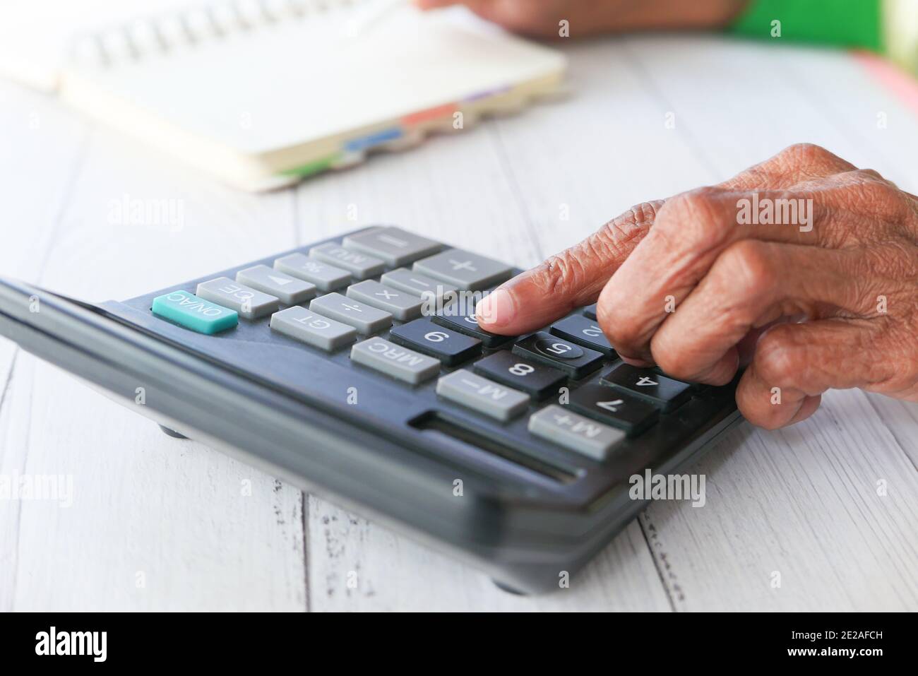 les femmes âgées se font main à l'aide de la calculatrice sur le bureau Banque D'Images