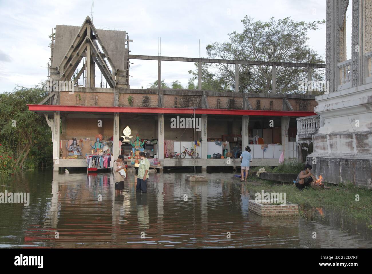 Les victimes des inondations traversent un quartier inondé dans un temple du district de Phatum Thani, dans le nord de Bangkok, alors que les eaux montantes menacent certaines parties de Bangkok, en Thaïlande, le 28 octobre 2011. Des centaines d'usines ont fermé dans la province centrale de la Thaïlande d'Ayutthaya et de Nonthaburi alors que les eaux d'inondation ont commencé à atteindre Bangkok. Selon le Département de la prévention et de l'atténuation des catastrophes, près de 370 personnes sont mortes dans des incidents liés aux inondations depuis la fin de juillet, la Thaïlande ayant connu les pires inondations depuis 50 ans. Photo de Frédéric Belge/ABACAPRESS.COM Banque D'Images