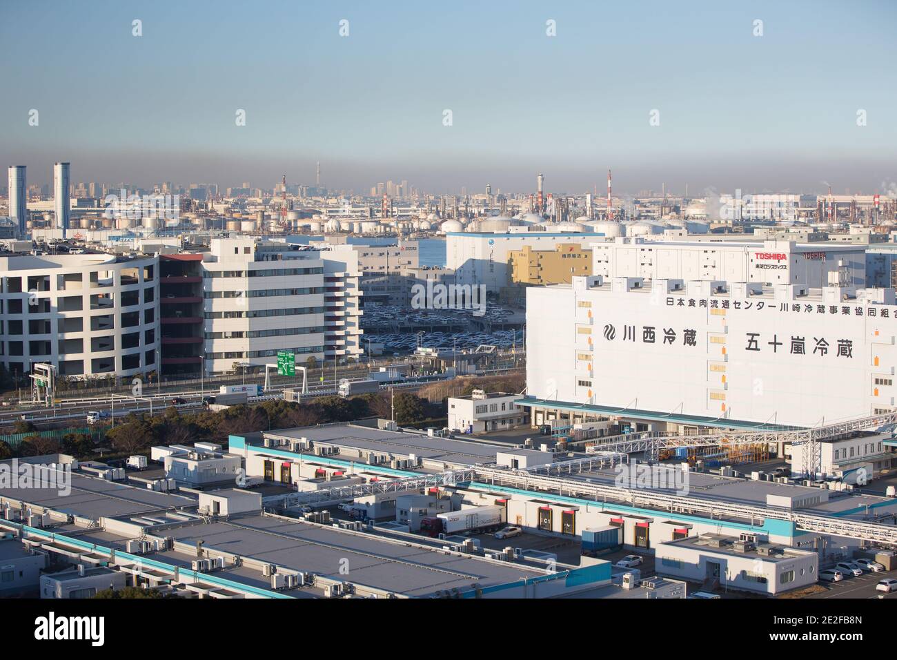 Tokyo a couvert une couche épaisse de smog vue de la zone industrielle de Kawasaki. La zone industrielle de kawasaki a connu une croissance rapide sous le boom économique japonais dans les 60' et 70' du siècle dernier. Elle est rapidement devenue le symbole de la pollution environnementale au Japon. Dans les 80' il y a eu de nombreuses poursuites contre les leaders de l'industrie pour les forcer à rendre leurs usines et leurs installations plus écologiques. De 2000 à 2008, la plupart des problèmes se sont résolus et maintenant l'air est beaucoup plus propre, que vous pouvez voir le Mont Fuji de là. Aussi la rivière Tama à proximité est devenue vivable pour les animaux et les poissons à nouveau. Banque D'Images