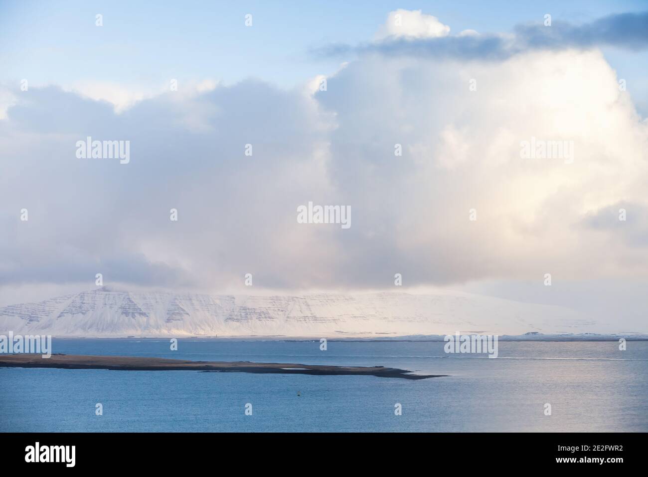 Paysage côtier islandais. Des montagnes enneigées sous un ciel nuageux le jour de l'hiver. Reykjavik, Islande Banque D'Images