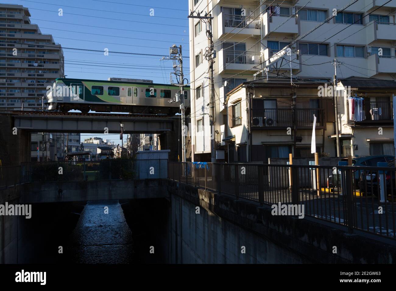 Un train de la ligne Tokyu Tamagawa série 7000 sur un pont au-dessus de la rivière Nimi près de la gare d'Ishikawa-dai Ota City, Tokyo, Japon. Banque D'Images