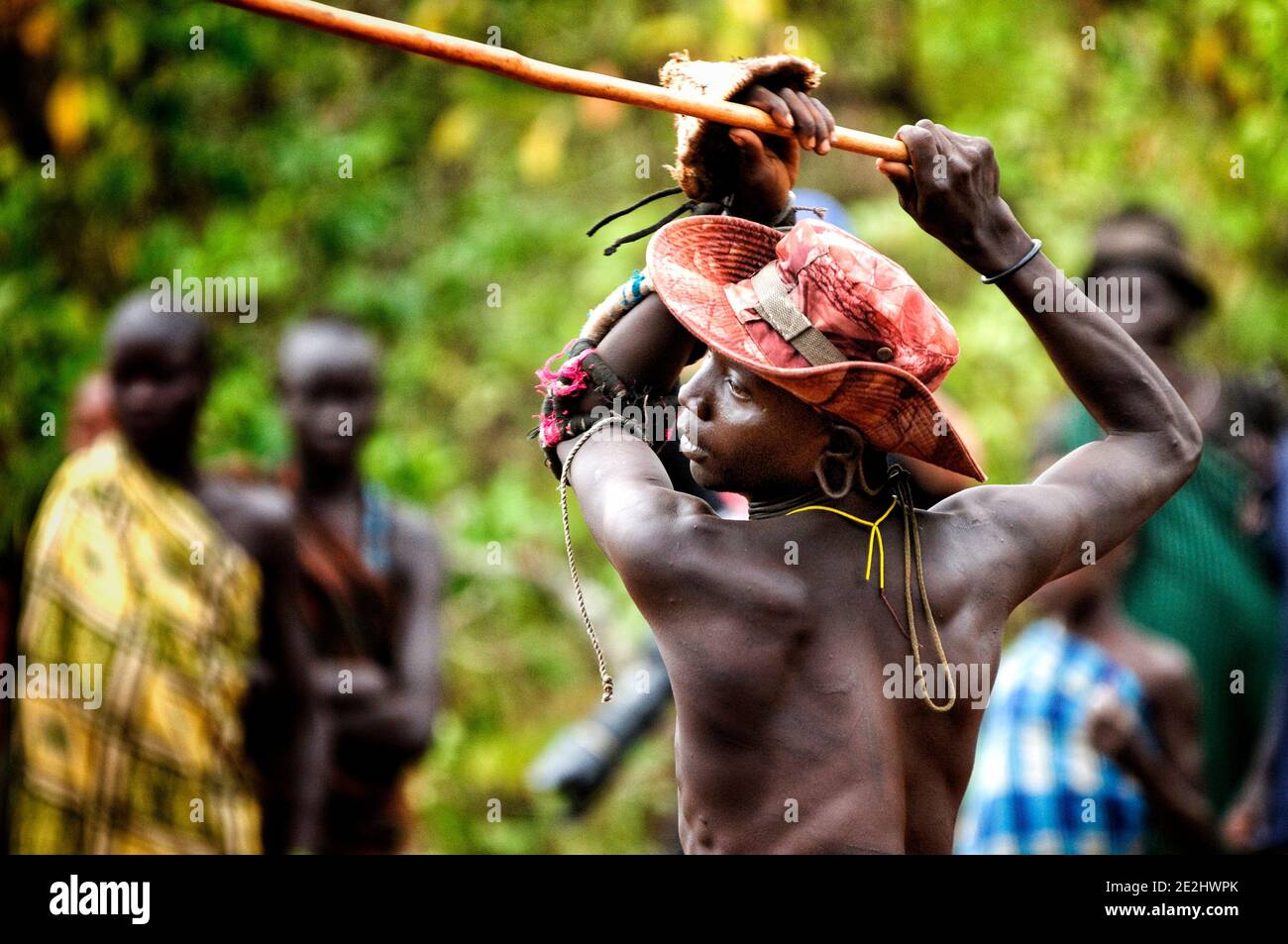 Cet homme de Suri lève son bâton dans la bataille. OMO VALLEY, ETHIOPIE: RENCONTREZ LA tribu qui s'engage dans un violent et sanglant bâton de combat avec le dernier homme standi Banque D'Images
