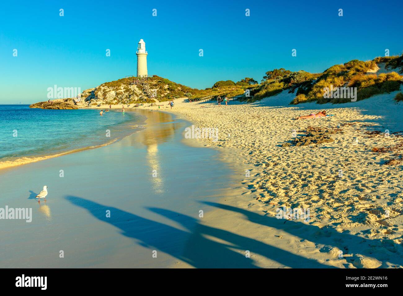 Rottnest Island, Australie occidentale - 4 janvier 2018 : les gens de Pinky Beach et du phare de Bathurst se reflètent sur la mer turquoise en fin d'après-midi. Nord Banque D'Images