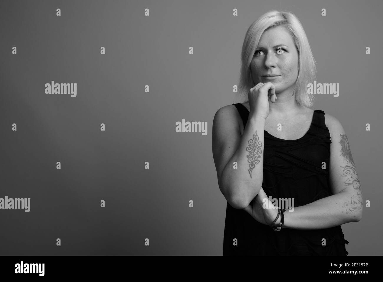 Femme aux cheveux blonds sur fond gris Banque D'Images