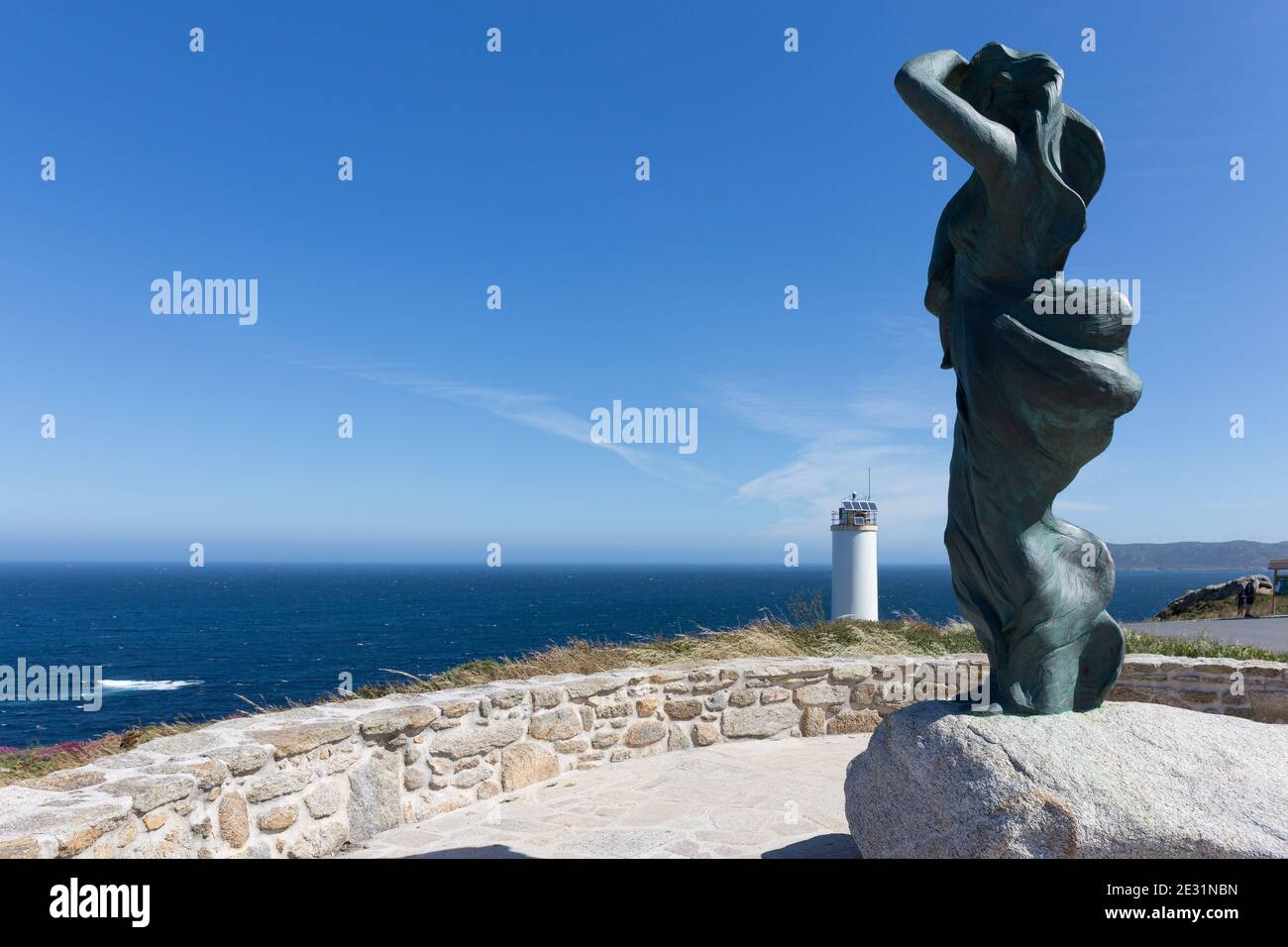 Memorial A Espera, sculpture mère et enfant par Iria Rodriguez et vue partielle sur le phare, Laxe, Galice, Espagne Banque D'Images