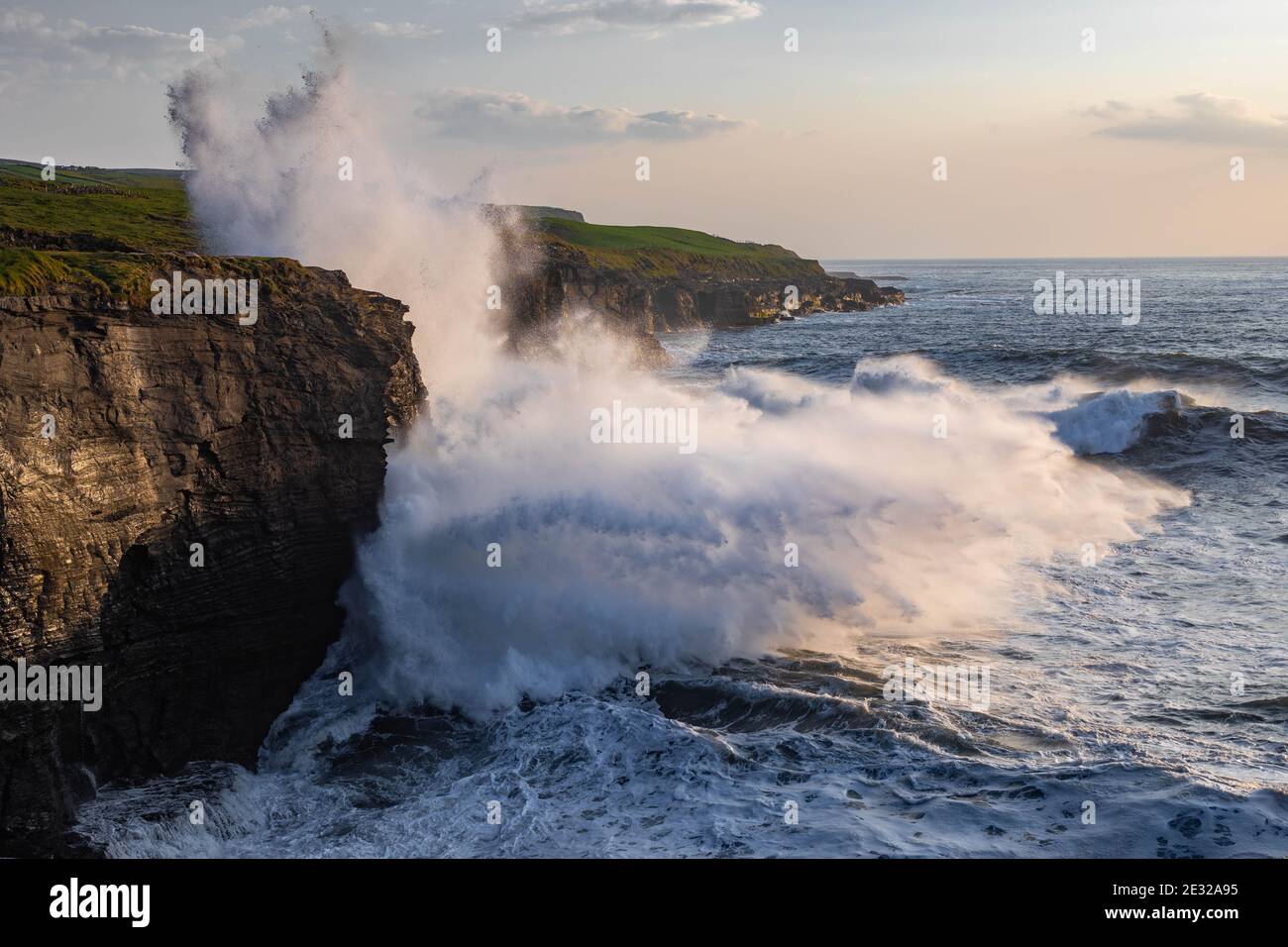 De grandes vagues s'écrasant contre les falaises au coucher du soleil à Doolin, Co. Clare Ireland, Wild Atlantic Way Banque D'Images