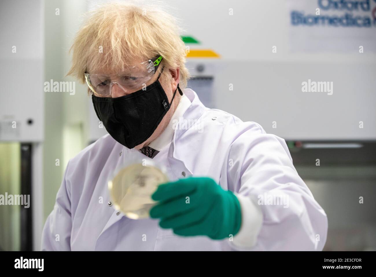 Le Premier ministre Boris Johnson examine une boîte de Petri dans le laboratoire de contrôle de la qualité, où des lots de vaccins sont testés, lors d'une visite de l'usine de fabrication du vaccin Oxford/AstraZeneca à Oxford Biomedica dans l'Oxfordshire. Date de la photo: Lundi 18 janvier 2021. Banque D'Images
