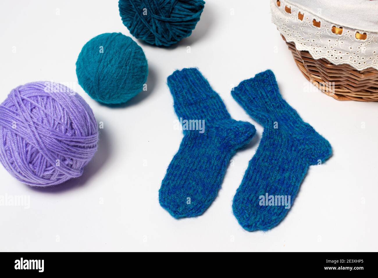 Chaussettes en laine tricotée bleue. Balles de fils multicolores pour tricoter, artisanat et passe-temps Banque D'Images