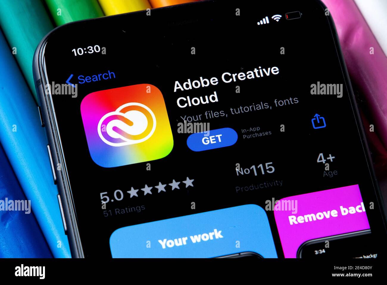 Application mobile Adobe Creative Cloud sur AppStore avec un arrière-plan en plastique coloré. Installation de Creative Cloud sur l'iPhone. Banque D'Images