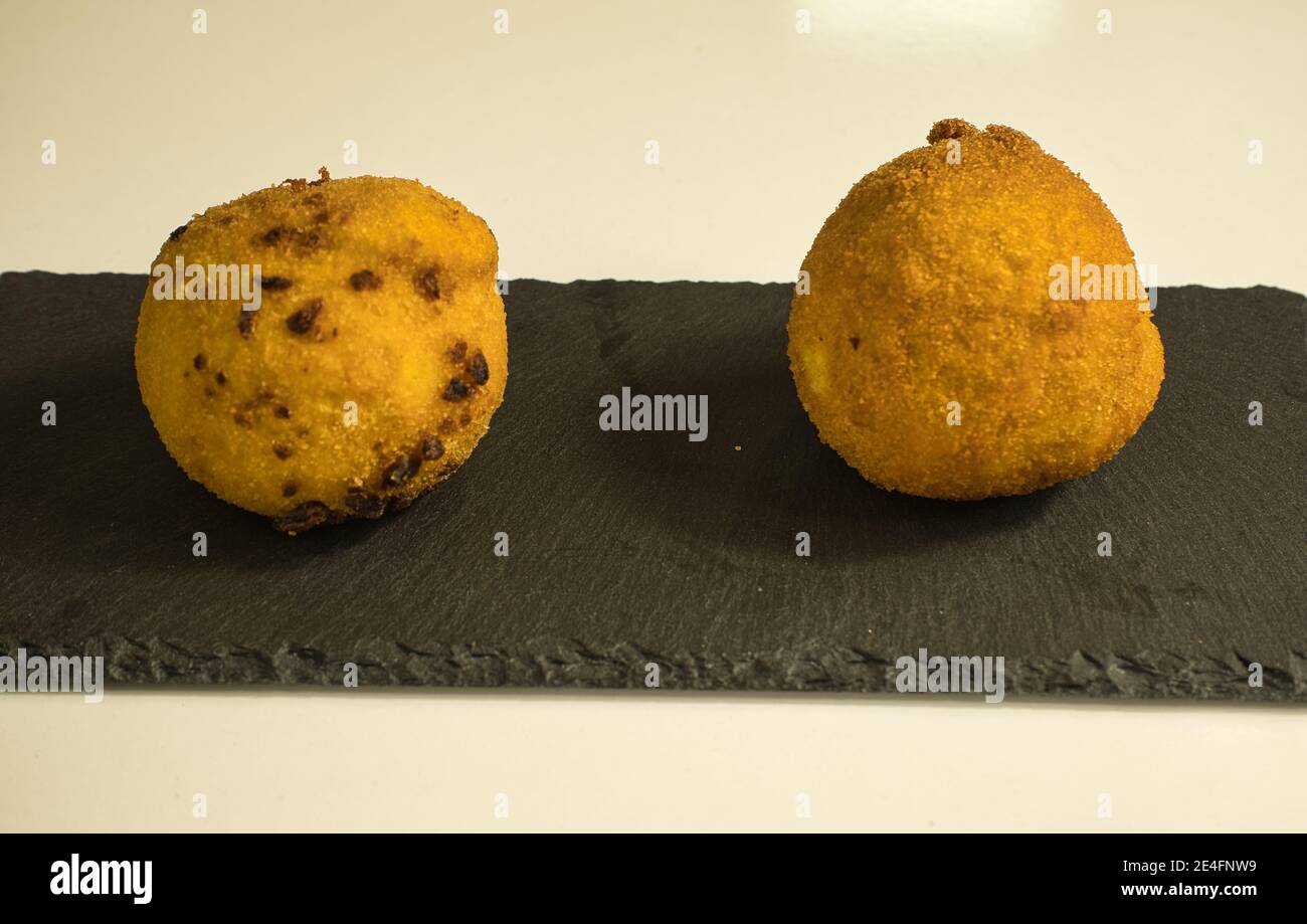 Hors-d'œuvre italienne arancini, boules de riz farcies à la viande cuite dans la graisse profonde, cuisine italienne Banque D'Images