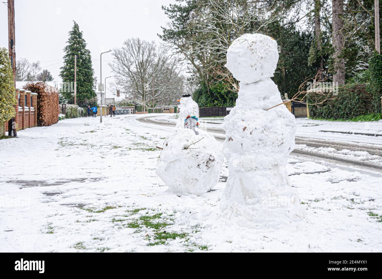 Un bonhomme de neige debout sur le côté d'une route à Reading, Berkshire, Royaume-Uni après la neige pendant la nuit. Banque D'Images