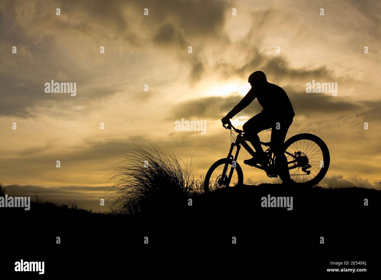 Silhouette de vélo au coucher du soleil, une personne, solo. Banque D'Images