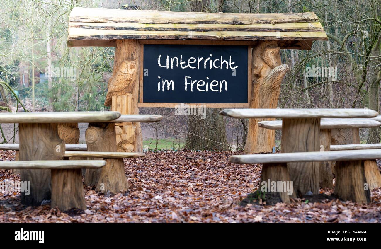 Une salle de classe dans la forêt. Enseigner pendant la pandémie de corona. Le tableau noir montre le texte allemand 'Unterricht im freien' (enseignement à l'extérieur). Banque D'Images