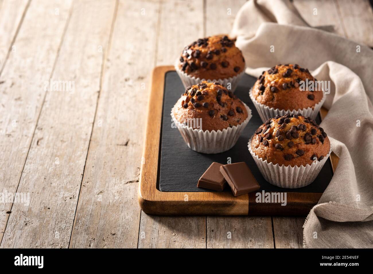 Des muffins au chocolat juste sortis du four sur une table en bois Banque D'Images