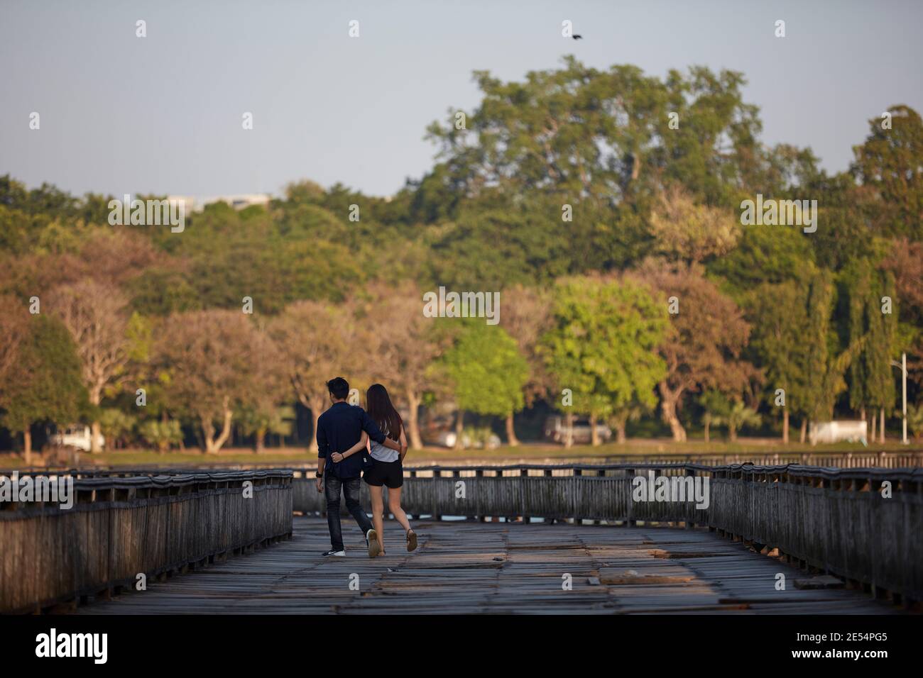 Un couple marche sur le pont en bois du lac de Kandawgyi, Yangon, Myanmar. Banque D'Images
