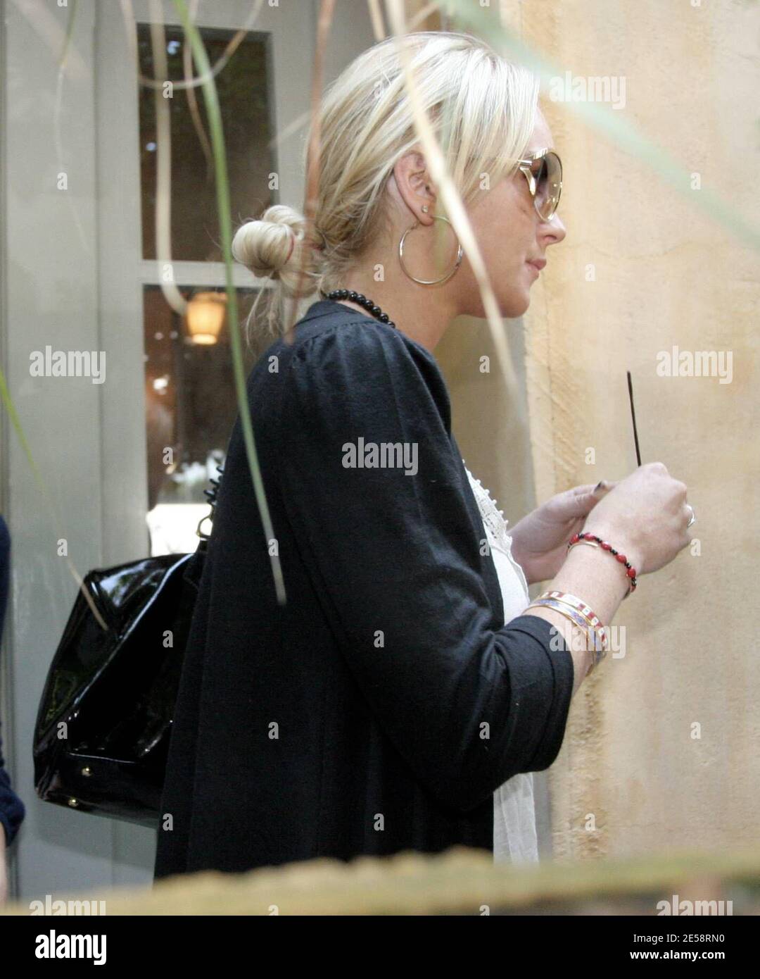 Lindsay Lohan a peut-être été en dehors de la chaux-lumière pendant deux mois en réadaptation, mais elle n'a pas perdu sa place sur les rangs des photos de célébrités incontournables. Lohan a fait son chemin à travers une énorme foule de photographes alors qu'elle sortait d'Orso après le déjeuner aujourd'hui. Lindsay ne semblait pas avoir à l'esprit l'attention, cependant, car elle semblait smirking comme elle se cacha derrière son garde de sécurité. Los Angeles, Californie, 10/17/07. [[rac ral]] Banque D'Images